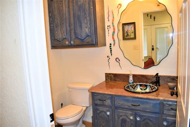 a bathroom with a toilet a sink and a mirror