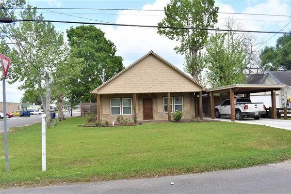 a view of a house with a yard and sitting area
