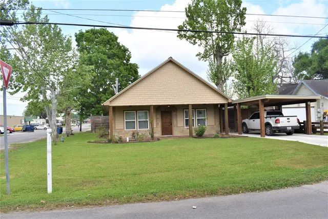 a view of a house with a yard and sitting area
