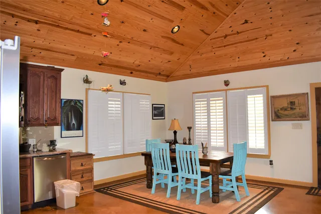 a dining room with wooden floor and furniture
