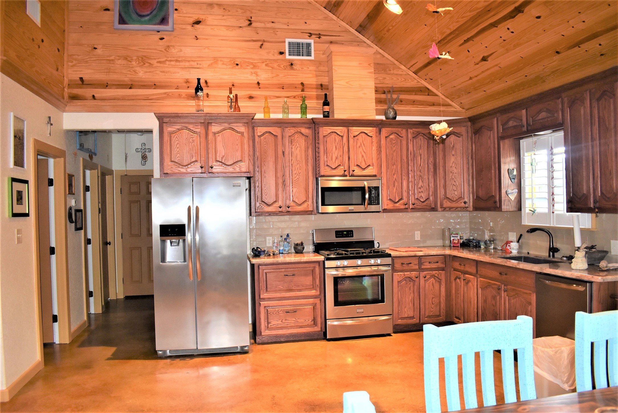 412 Pecan Street Sweeny, TX 77480 - Photo 10 of 32 a kitchen with stainless steel appliances granite countertop a sink a stove and a refrigerator