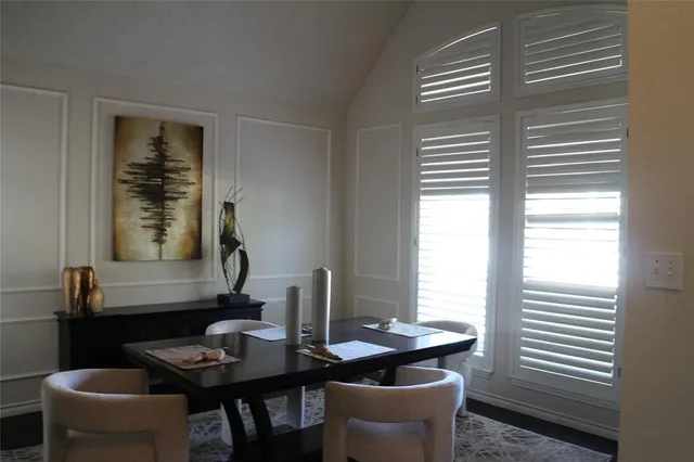 a dining room with furniture and window