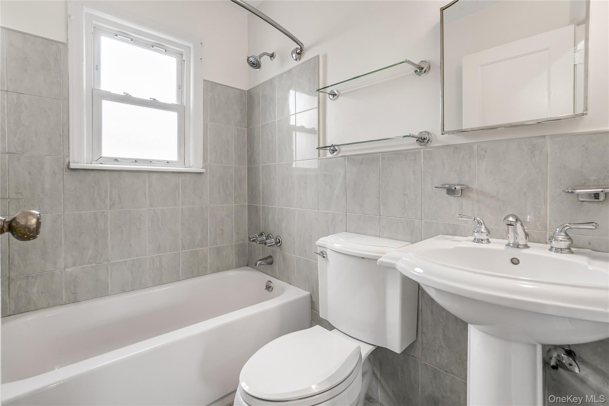 243-25 132nd Road Queens, NY 11422 - Photo 12 of 41 a bathroom with a sink a toilet and bathtub