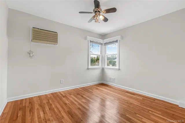 a view of a room with wooden floor and windows