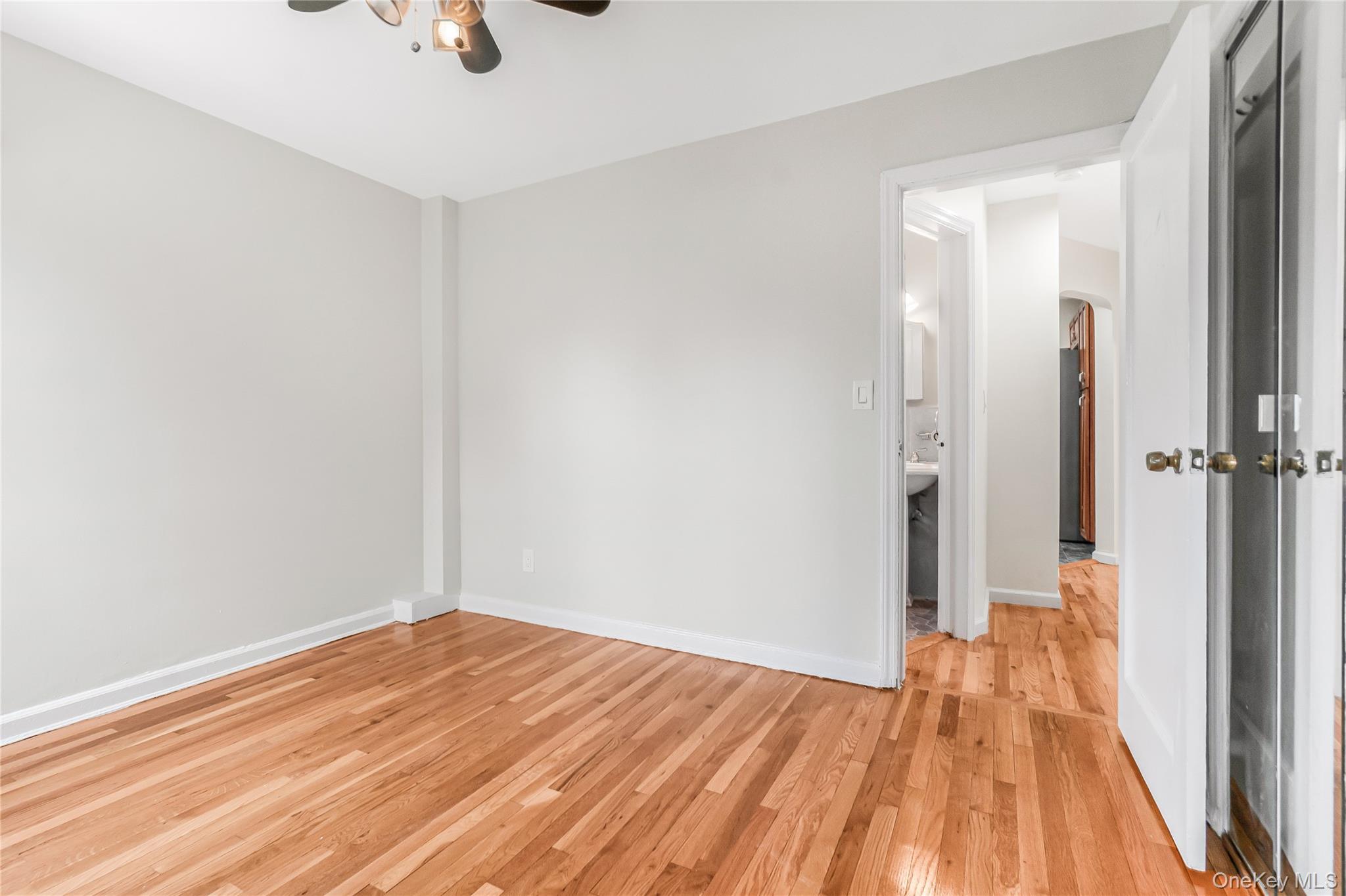 243-25 132nd Road Queens, NY 11422 - Photo 14 of 41 a view of a room with wooden floor and a ceiling fan