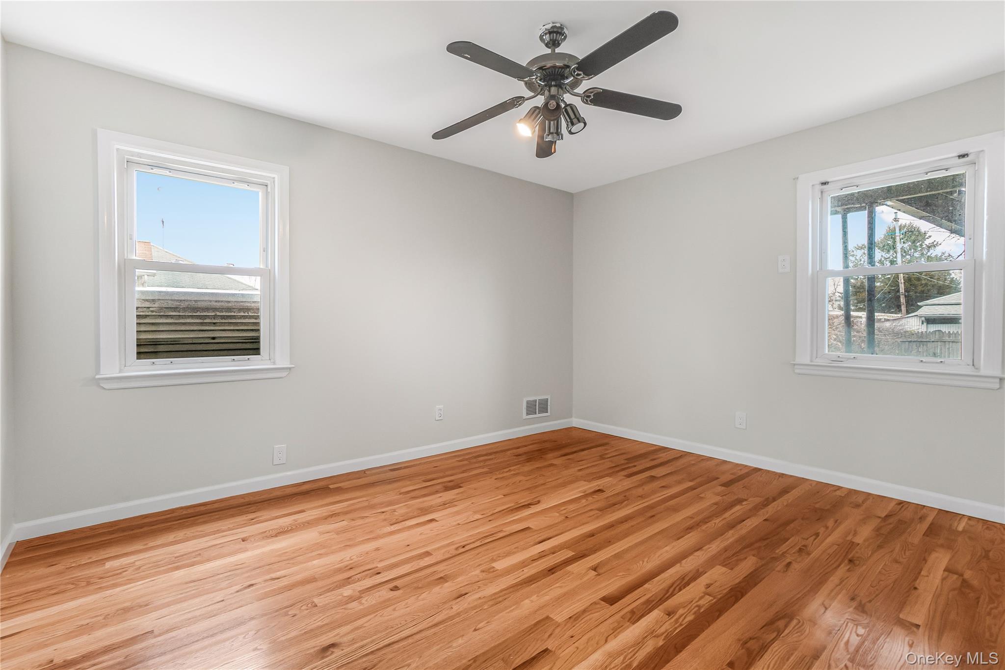 243-25 132nd Road Queens, NY 11422 - Photo 15 of 41 a view of empty room with wooden floor and fan