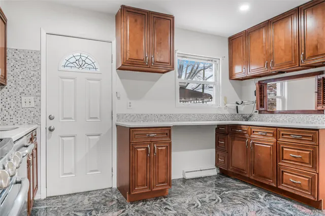 a kitchen with stainless steel appliances granite countertop a refrigerator and cabinets
