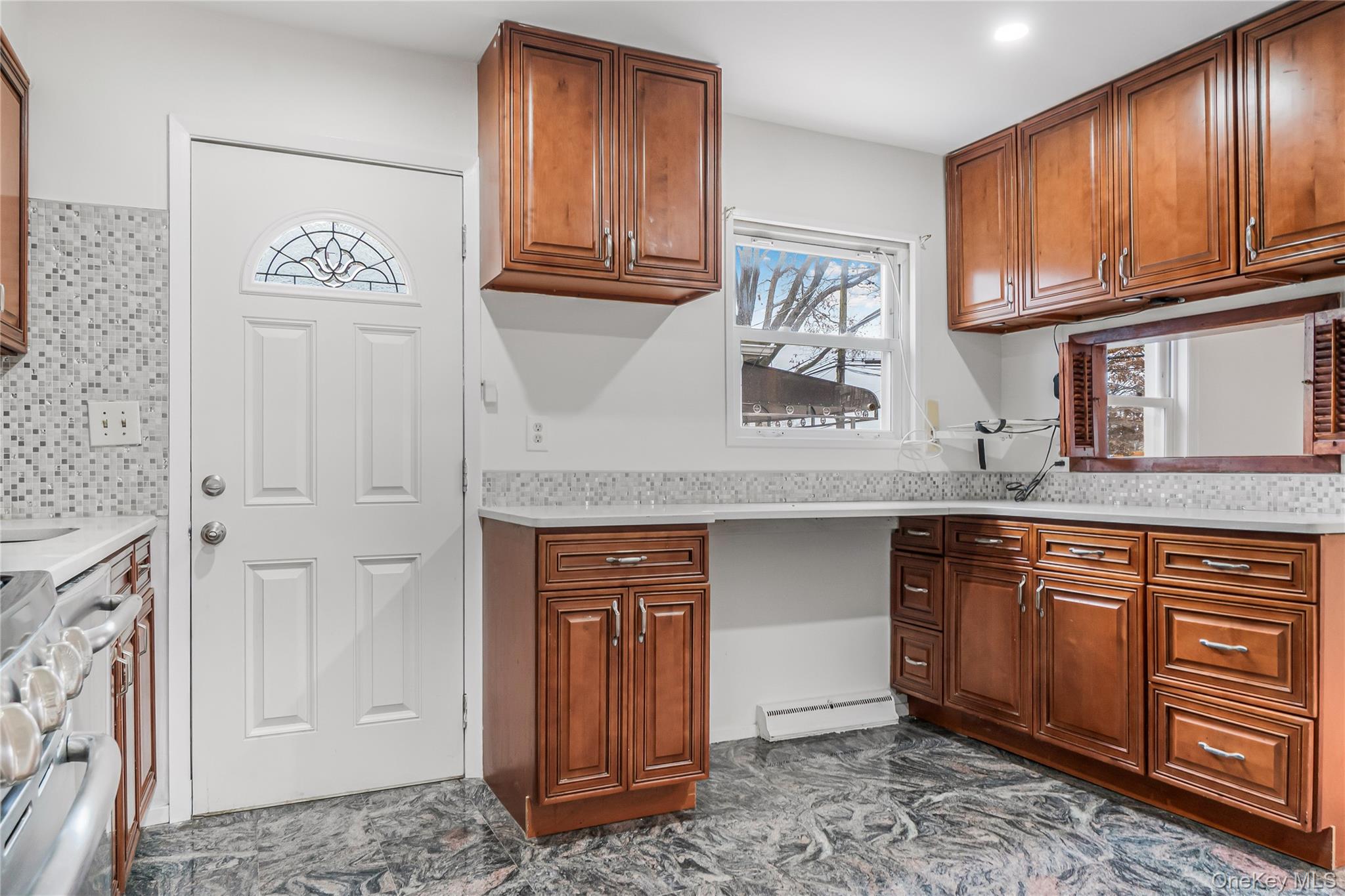 243-25 132nd Road Queens, NY 11422 - Photo 19 of 41 a kitchen with stainless steel appliances granite countertop a refrigerator and cabinets