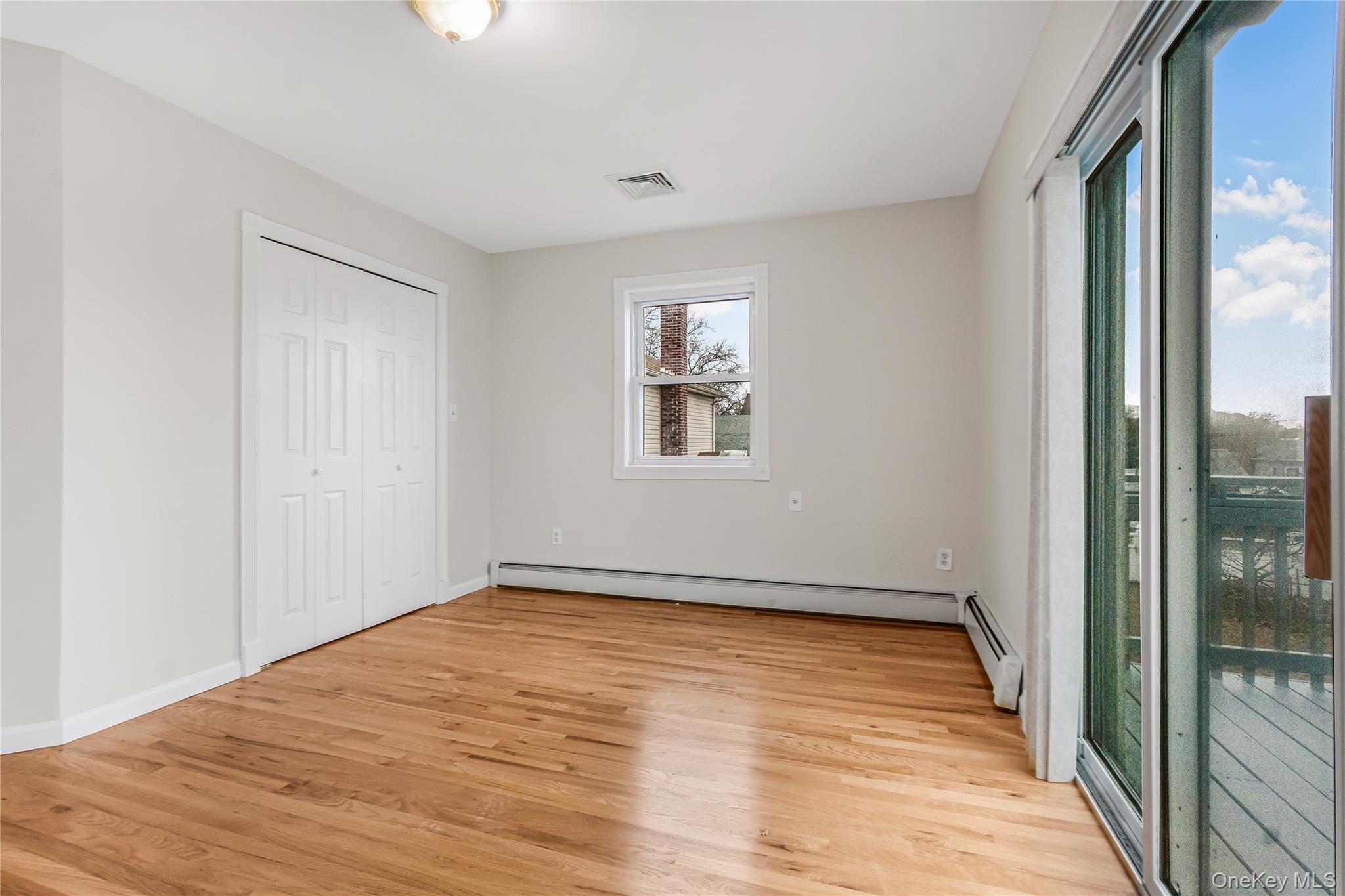 243-25 132nd Road Queens, NY 11422 - Photo 27 of 41 a view of empty room with wooden floor and fan