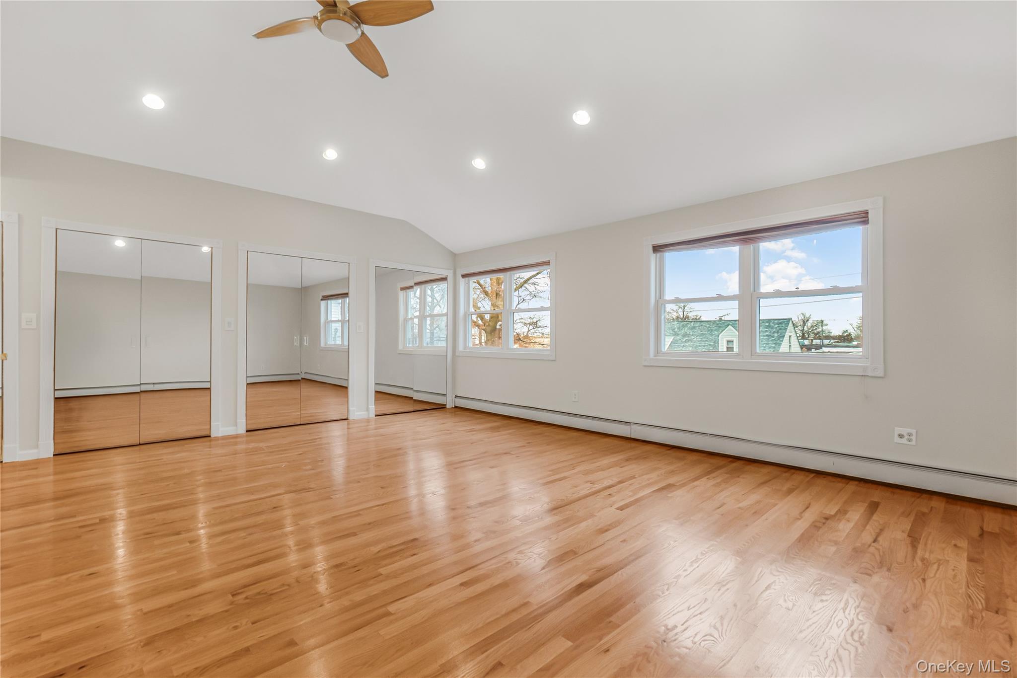 243-25 132nd Road Queens, NY 11422 - Photo 29 of 41 an empty room with wooden floor and windows