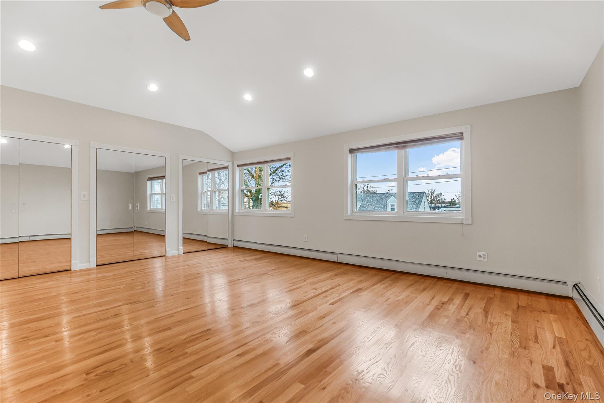 243-25 132nd Road Queens, NY 11422 - Photo 30 of 41 an empty room with wooden floor and windows