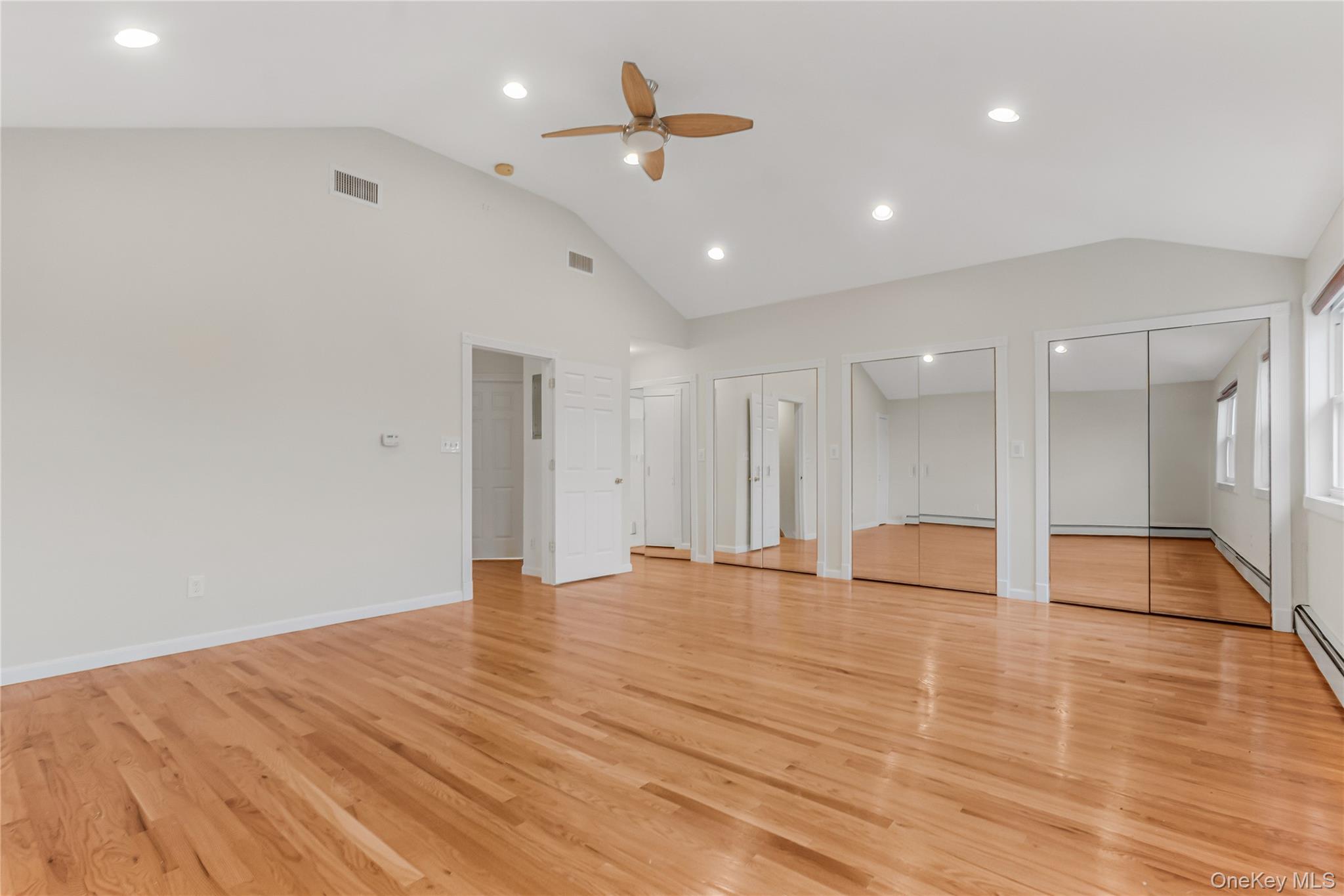 243-25 132nd Road Queens, NY 11422 - Photo 31 of 41 a view of an empty room with wooden floor and a ceiling fan