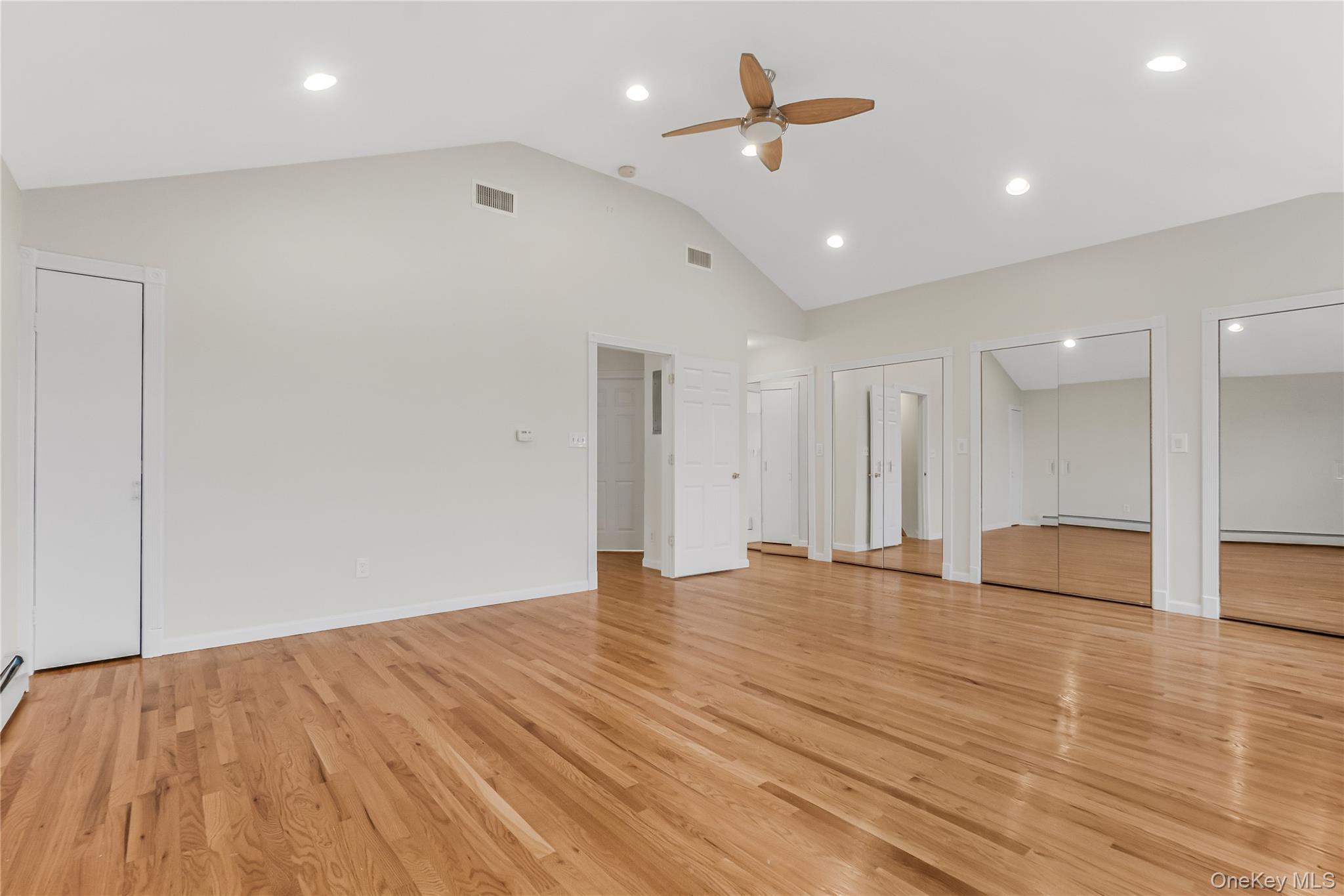 243-25 132nd Road Queens, NY 11422 - Photo 32 of 41 a view of an empty room with wooden floor and a ceiling fan