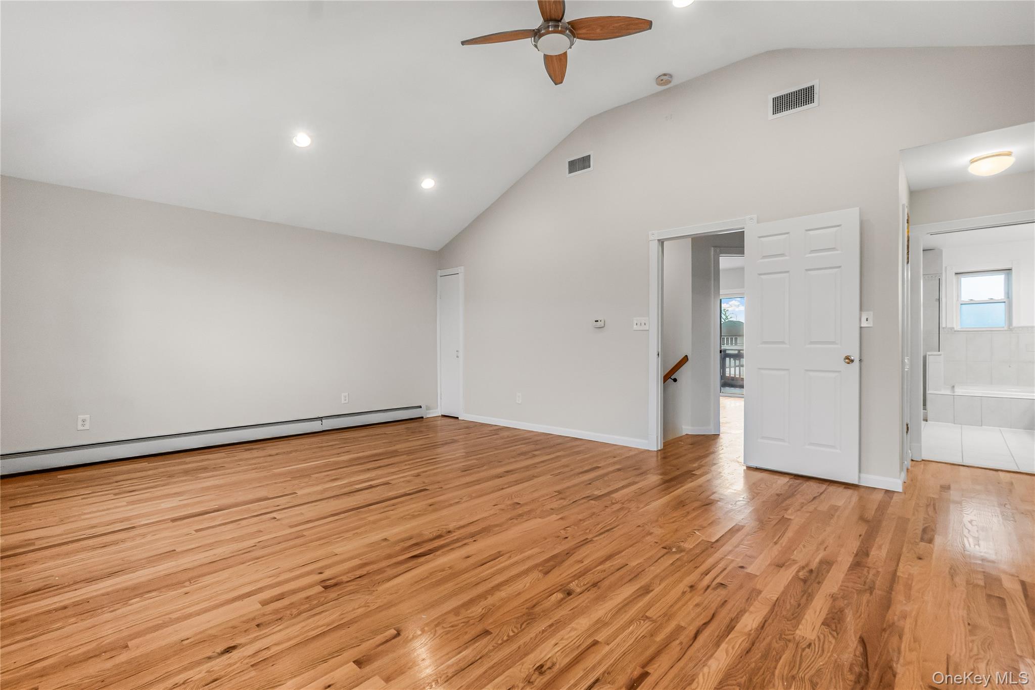 243-25 132nd Road Queens, NY 11422 - Photo 33 of 41 a view of an empty room with wooden floor