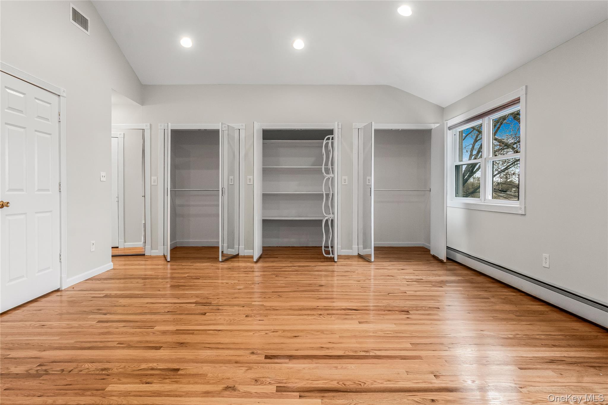 243-25 132nd Road Queens, NY 11422 - Photo 34 of 41 an empty room with wooden floor and window