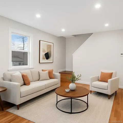 a living room with furniture a rug and a table