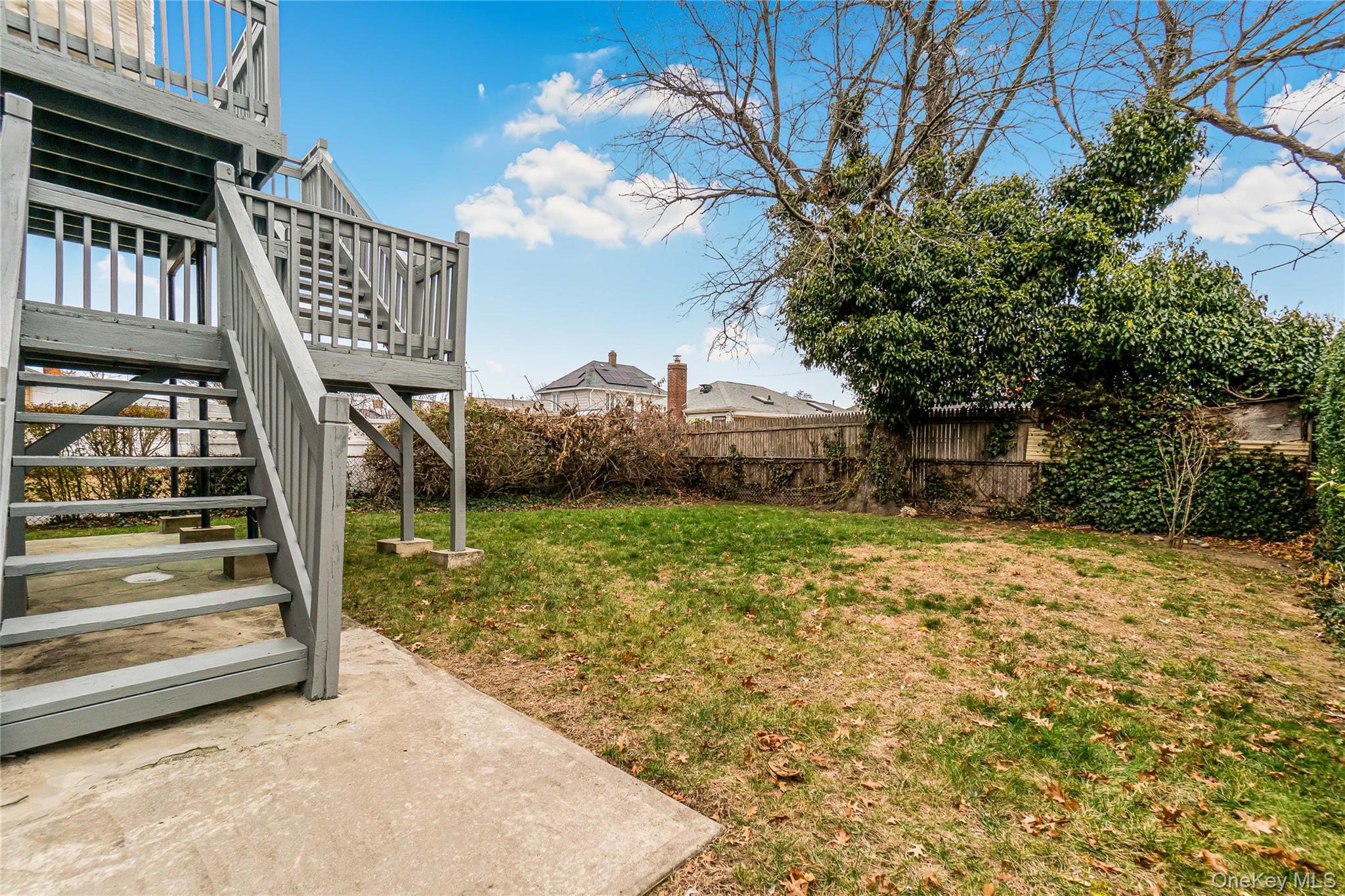 243-25 132nd Road Queens, NY 11422 - Photo 5 of 41 a backyard of a house with lots of green space