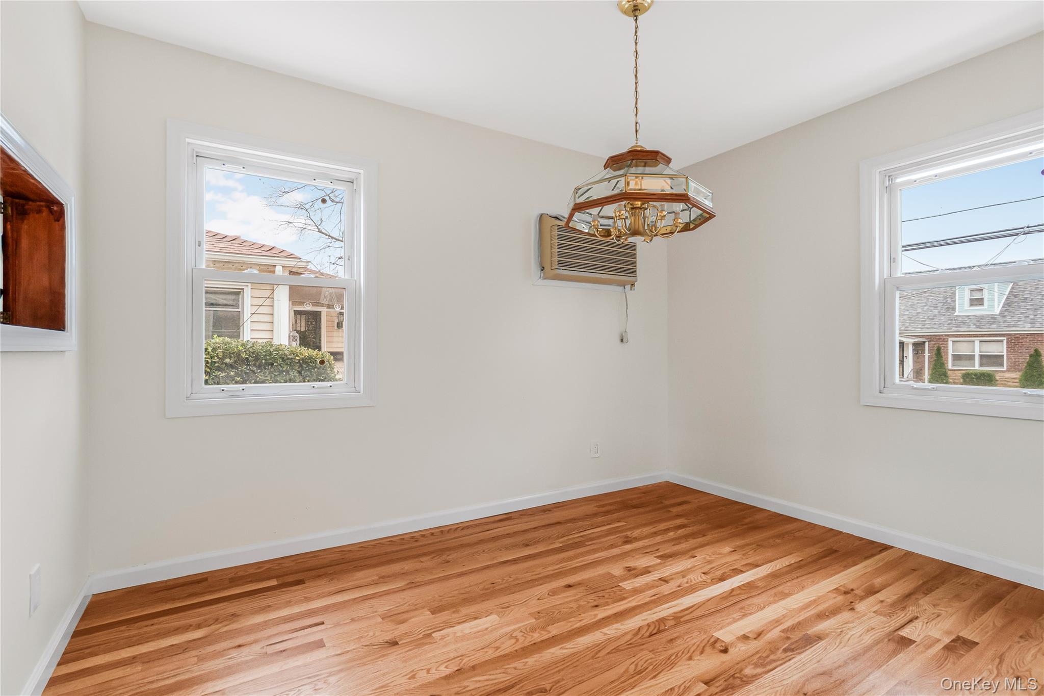 243-25 132nd Road Queens, NY 11422 - Photo 7 of 41 a room with a window and a wooden floor
