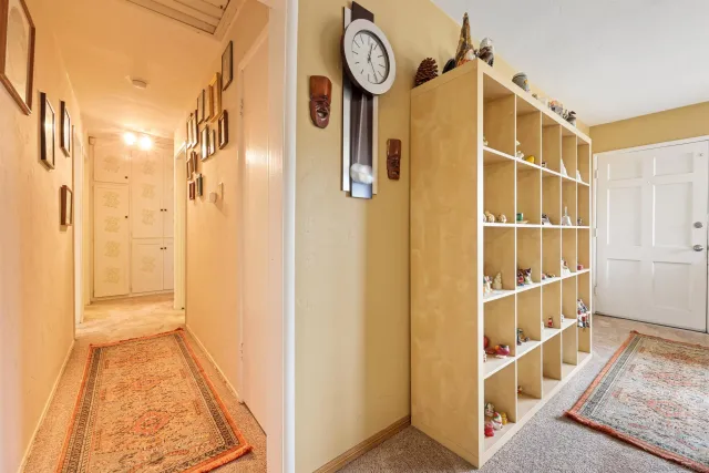 a view of a hallway with wooden floor and entryway