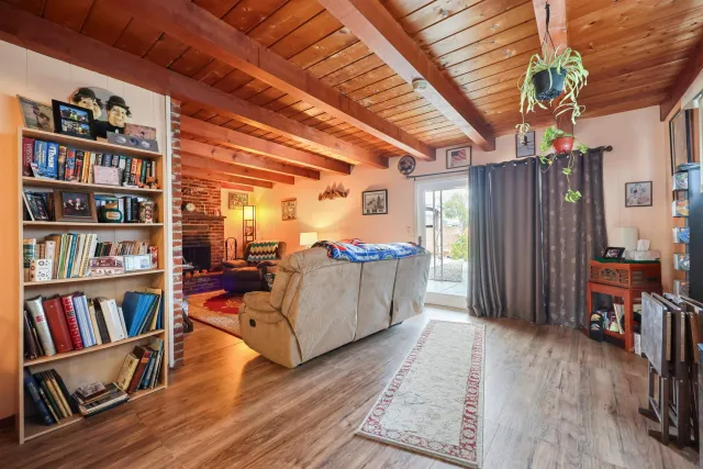 a living room with furniture and a book shelf