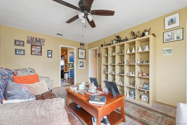 a living room with a couch and a bookshelf