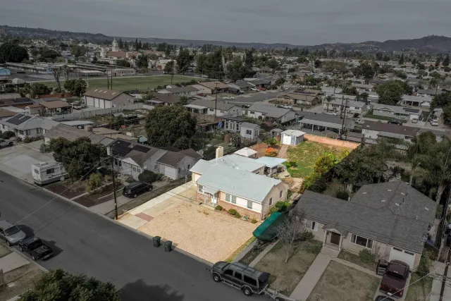 an aerial view of a house with a yard