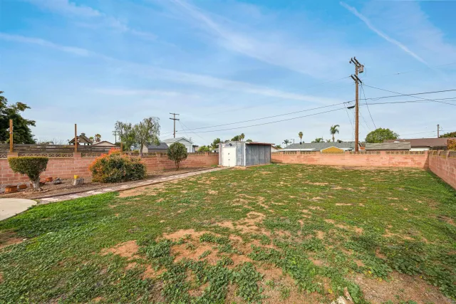 a view of a water fountain and floor to ceiling window and yard