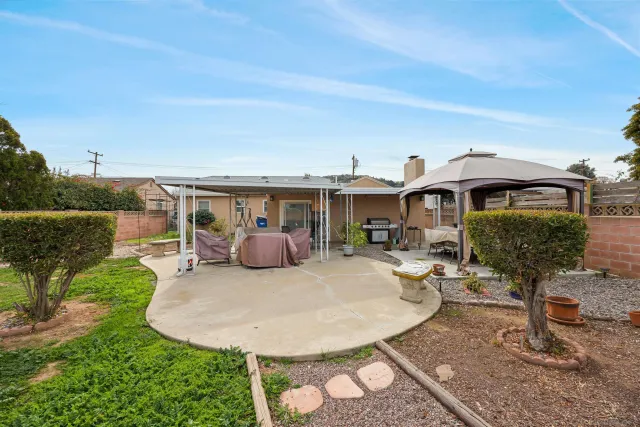 a view of a house with backyard porch and furniture