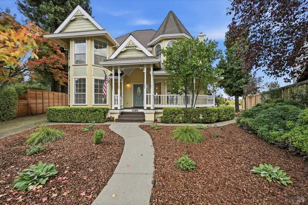a front view of a house with yard and green space
