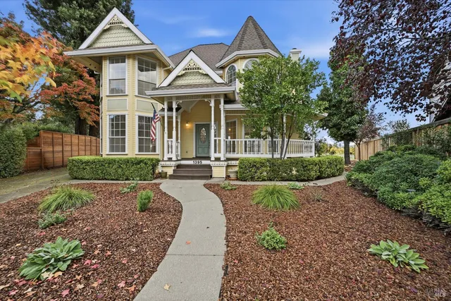 a front view of a house with yard and green space
