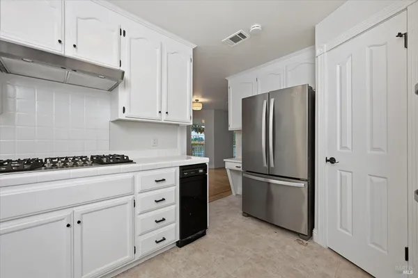 a kitchen with cabinets and stainless steel appliances