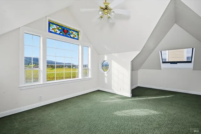 a view of empty room with windows and fireplace