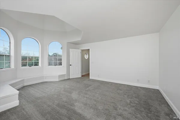 a view of a livingroom with a ceiling fan and window
