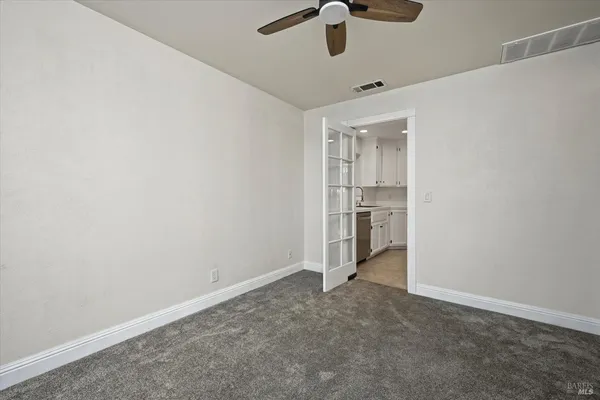 a view of a house with a wooden fence