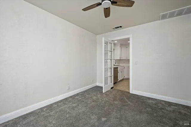 a view of a house with a wooden fence