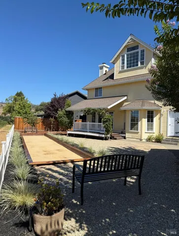 a view of a house with pool and chairs