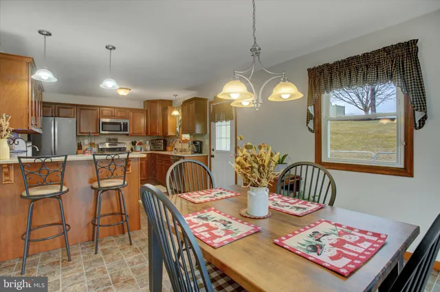 a dining room with furniture and a chandelier