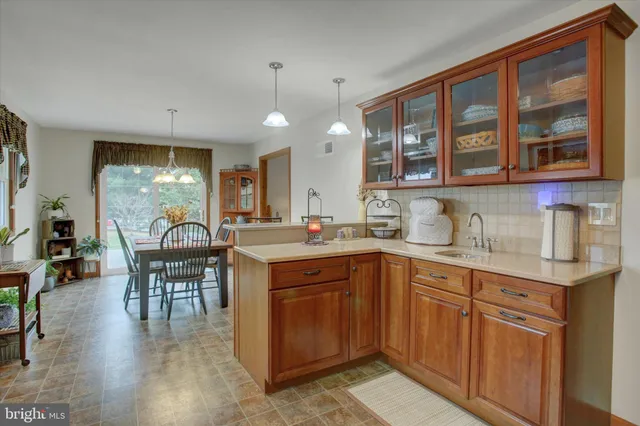 a kitchen with lots of counter top space and dining table