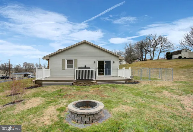 a view of a house with swimming pool and a yard