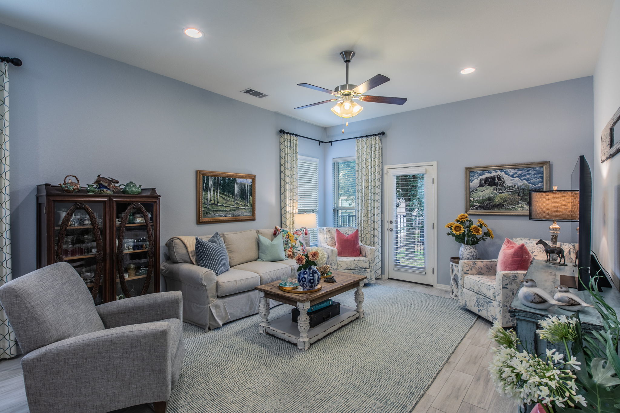 231 Simon Kyle, TX 78640 - Photo 5 of 29 Spacious living area featuring light gray walls and wood-finish flooring