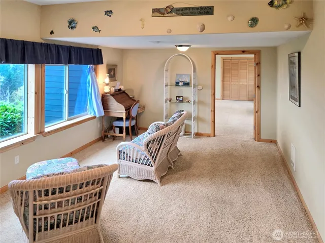 a living room with furniture a wooden floor and a large window