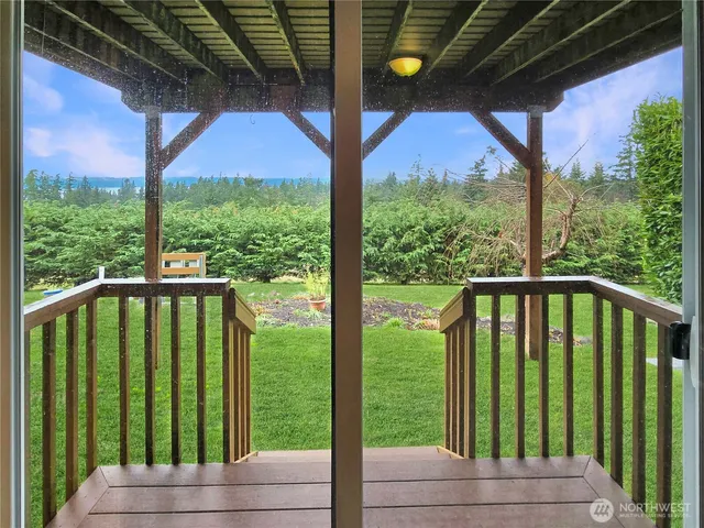 a view of balcony with yard and mountain view