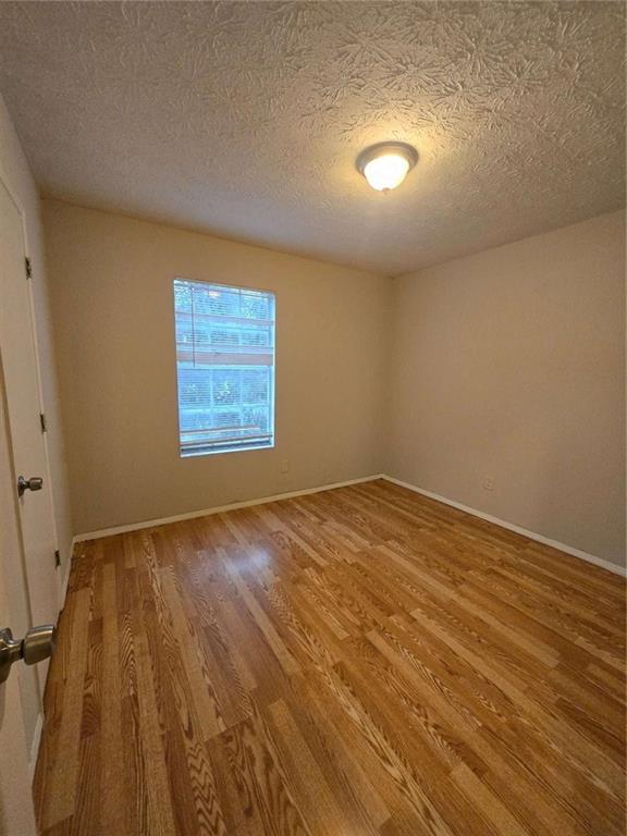 1717 Rondon Court Atlanta, GA 30316 - Photo 6 of 12 an empty room with wooden floor and windows
