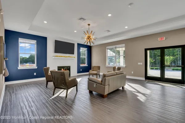 a living room with fireplace furniture and a wooden floor