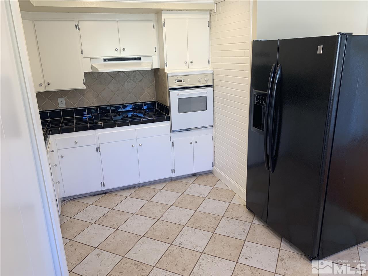 1755 West 6th Street Reno, NV 89503 - Photo 7 of 14 a kitchen with stainless steel appliances a refrigerator and cabinets