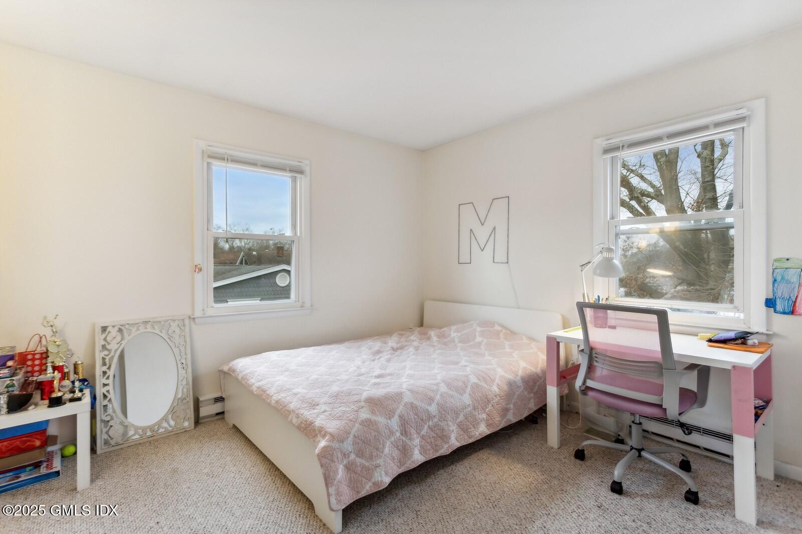 15 Neil Lane, Unit 2 Riverside, CT 06878 - Photo 7 of 10 a bedroom with a bed and a window