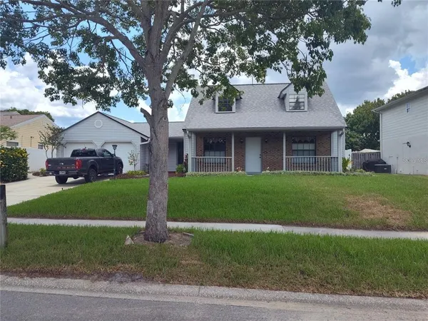 a front view of a house with a garden and yard