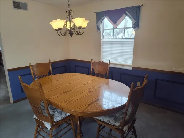 a view of a dining room with furniture and window