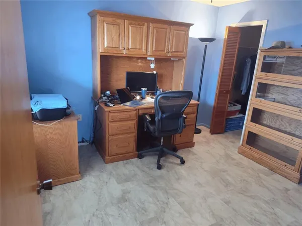 a view of workspace with furniture and a gate