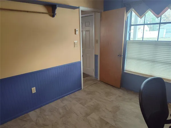 a view of room with windows and wardrobe